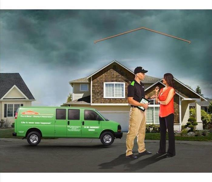 SERVPRO technician consulting with customer