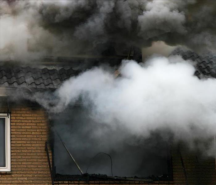 billowing smoke from a house fire
