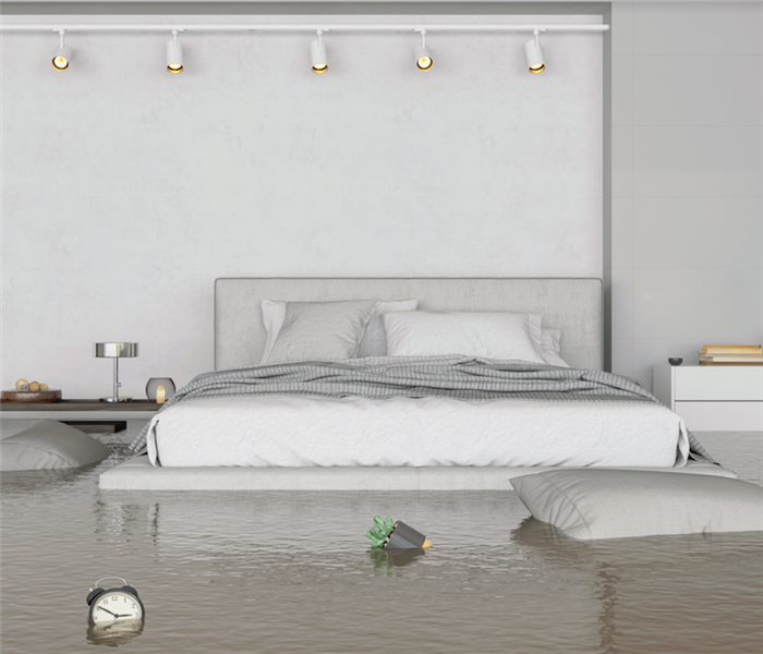 a flooded bedroom with furniture floating around everywhere